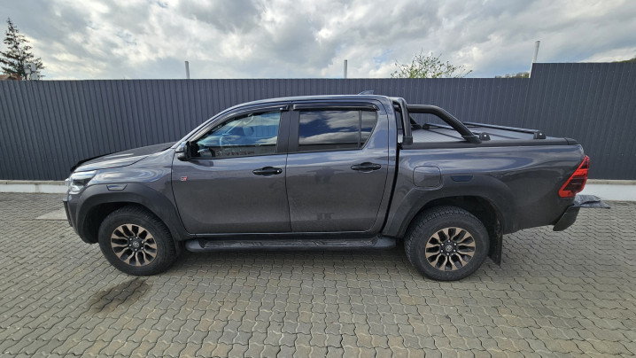 Bed liner, roll cover, rollbar, cross bars, window visors installed on Hilux GR Sport